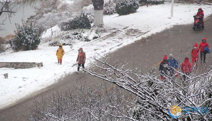 山东威海今再迎降雪 市民雪中出行风中俏丽