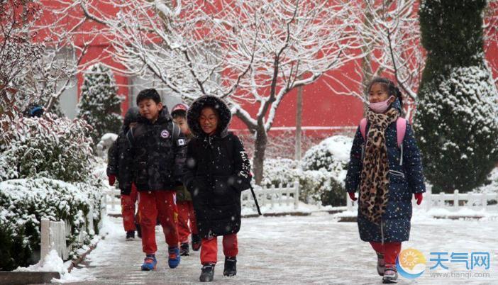 山东威海今再迎降雪 市民雪中出行风中俏丽