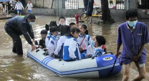 海口突降暴雨多条路段积水严重 学校学生坐皮划艇上学引围观